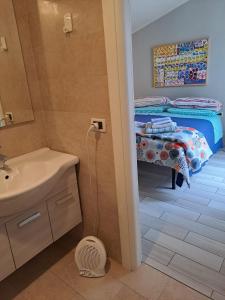 a bathroom with a sink and a bed in a room at B&B Monolocale Piazza Dante in Teramo