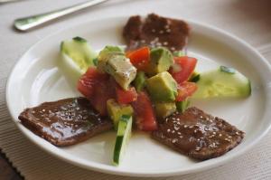 a plate of food with meat and vegetables on a table at Meru House Lekisilai in Arusha