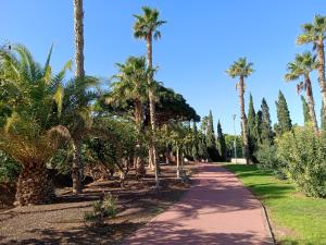 a path with palm trees and a blue sky at Christian in Cruce de Arinaga