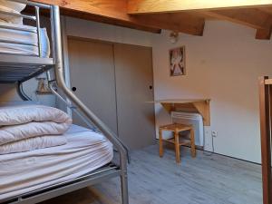 a bunk bed in a room with a fireplace at Local Vélo - Studio en pleine nature Puyvalador in Puyvalador