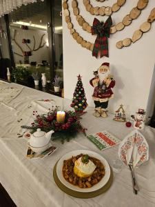 a table with a plate of food and a christmas decoration at Belvedere Resort Moieciu in Moieciu de Jos