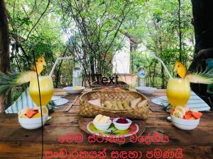 a wooden table with food and drinks on it at Grand freedom in Sigiriya