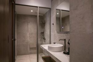 a bathroom with a sink and a shower at Μikri Arktos Boutique Hotel in Dhimitsana