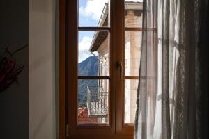 an open window with a view of a mountain at Μikri Arktos Boutique Hotel in Dhimitsana