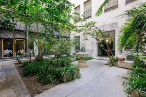 a courtyard in a building with trees and a fountain at Stunning Apartment near Gran Via Metro in Madrid