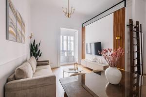 a living room with a couch and a table at Stunning Apartment near Gran Via Metro in Madrid