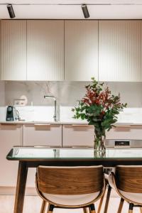 a kitchen with a table with a vase of flowers on it at Stunning Apartment near Gran Via Metro in Madrid