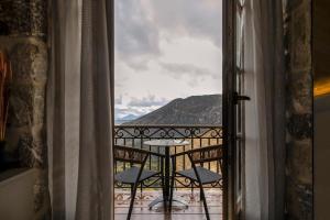 a view of a balcony with a table and chairs at Μikri Arktos Boutique Hotel in Dhimitsana