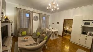 a living room with a table and chairs and a dining room at Old Town Apartment Ana in Sibiu