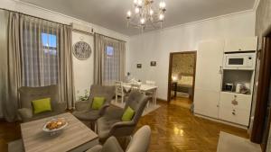 a living room with a table and a dining room at Old Town Apartment Ana in Sibiu