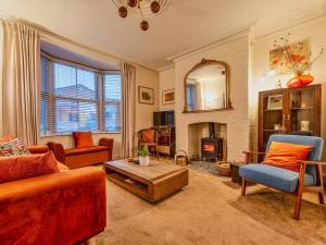 a living room with a couch and a fire place at Charming Victorian Hidden Gem - Pass the Keys in Market Drayton