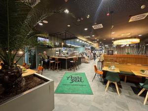 a restaurant with tables and chairs and a sign that reads just you at AUSZEIT DAS HOTEL Asbach-Bäumenheim & AUSZEIT DAS RESTAURANT in Asbach-Bäumenheim