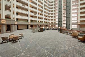 an empty lobby of a large building with chairs and tables at Cincinnati Marriott at RiverCenter in Covington