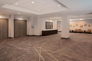 a large room with a waiting area in a building at Cincinnati Marriott at RiverCenter in Covington