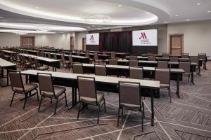 a conference room with tables and chairs and a screen at Cincinnati Marriott at RiverCenter in Covington +37 photos