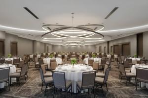 a banquet room with tables and chairs and a chandelier at Cincinnati Marriott at RiverCenter in Covington