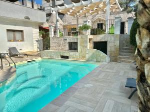 a swimming pool in front of a house at Savito Guest House in Martina Franca