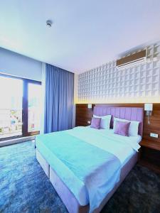 a bedroom with a large bed with a large window at FERNWEH No 5 Boutique Hotel MAMAIA Nord in Mamaia Sat/Năvodari
