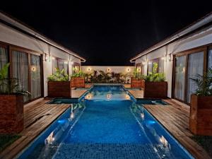 a swimming pool in a backyard at night at Vila Mandakaru in São Miguel do Gostoso +20 photos
