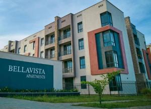 a building with a sign in front of it at Decent and cosy one bed flat - Bella Vista in Entebbe