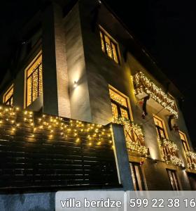 a building with christmas lights on it at night at villa beridze in Borjomi