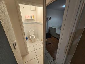 a small bathroom with a toilet in a room at Chambre centre ville de Cluses in Cluses