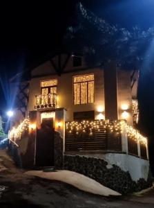 a house decorated with christmas lights at night at villa beridze in Borjomi