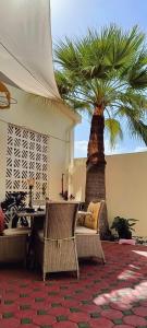 a room with a table and a palm tree at Jumeirah Beach Villa in Dubai
