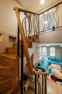 eine Treppe in einem Wohnzimmer mit einem blauen Sofa in der Unterkunft Villa Green Magic in Schipka