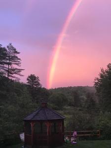a rainbow in the sky over a gazebo at Cozy 1882 renovated cape in Plainfield