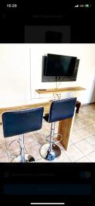 a desk with two chairs and a computer monitor at Central appartment 2 with parking in Larisa +4 photos