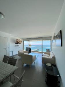 a living room with a view of the ocean at Condominio Nuevo Paracas - Sotavento in Paracas