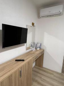 a flat screen tv on a wall in a room at Royal Stars Apartments in Strumica +7 photos