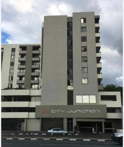 a building with a car parked in front of it at City junction studio apartment in Windhoek