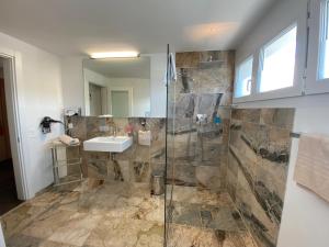 a bathroom with a shower and a sink at Businesshotel Lux in Lucerne