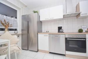 a kitchen with stainless steel appliances and white cabinets at KU01-RI Apartment in Kulmbach EG in Kulmbach