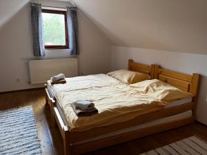a bedroom with a bed with two towels on it at Chata Mojer in Ždiar