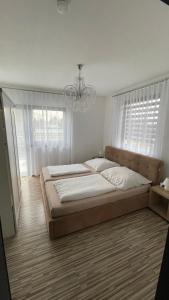 a bedroom with a large bed and a chandelier at Ferienwohnung Fink in Berlin