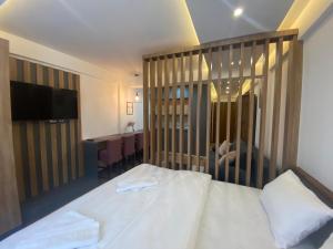 a bedroom with a bed with a wooden head board at VortexLux in Kopaonik +33 photos