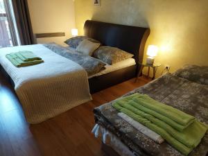 a bedroom with two beds and a couch at Cozy family apartment with garage in Donovaly