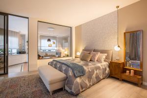 a bedroom with a bed and a large mirror at TRENTINO LODGE Piazza Municipio in Strigno