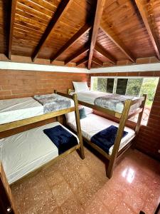 Zimmer mit 3 Etagenbetten in einem Haus in der Unterkunft Casa de campo cerca a Medellín in Titiribí