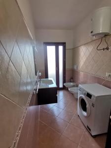 bagno con servizi igienici, lavandino e lavatrice di Su Montixeddu a Tertenìa
