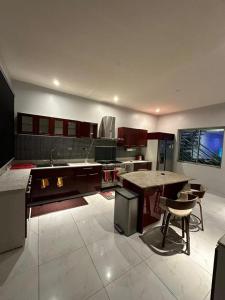a large kitchen with a table and some chairs at Blue Bell Suites in Lekki