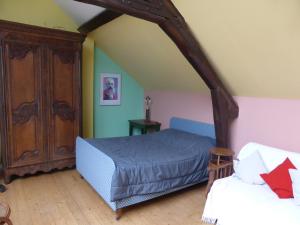 - une chambre avec un lit et une commode dans l'établissement Les Buissonnets, à Giverny
