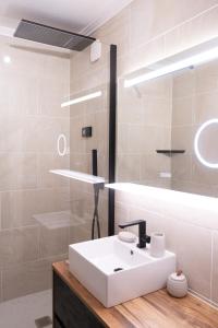 a bathroom with a white sink and a mirror at Studio cabine « Au Loup Blanc » in Saint-Gervais-les-Bains