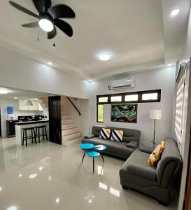 a living room with a couch and a ceiling fan at Nestor's Apartment 