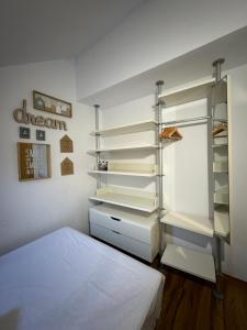 a bedroom with a bed and a closet with shelves at Acogedor Ático en el Corazón de Formigal in Formigal