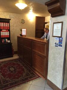 a man standing at a counter in a room at Hotel Malibran in Venice