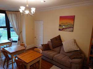 a living room with a couch and a table at Thorndene B&B in Hope